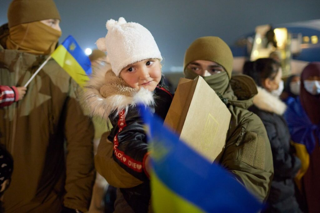 Man holding little girl with a ukrainian flag